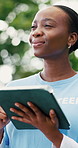 Volunteer, tablet and black woman in park, thinking and program for donation, connection and choice. NGO, planning and person with tech, social responsibility and app for sign up and problem solving