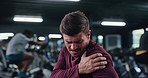 Athlete, man and massage with shoulder pain at gym for fitness injury, muscle strain and ache. Male person, cramps and arm inflammation from workout accident, exercise mistake and fibromyalgia sprain