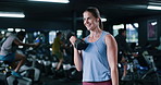 Fitness, dumbbell or woman in club with earphones, song choice or bicep curl in bodybuilding. Exercise, music streaming or athlete in gym with tech, intense workout or muscle gain in weightlifting