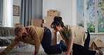 Couple, rolling carpet and happy in new home, moving and interior design for flooring with real estate. Man, woman and helping hand with partner, mat and boxes at apartment, relocation and property