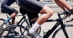 Sports, cycling and legs of men on bicycle in city for fitness, training and exercise for endurance. Town, athlete and people for competition, race and challenge for workout, wellness and health