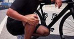 Man, cyclist and bicycle with knee pain for accident, fitness strain or sprain in city street. Closeup, male person or biker with sore leg for cycling injury or joint inflammation in an urban town