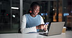 Happy, black woman or night with laptop or phone for social media, network or chatting in office. Female person, typing or texting with mobile smartphone or computer in late evening for communication