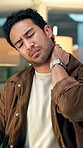 Burnout, strain and businessman in office with neck pain, injury or fibromyalgia for bad posture. Tired, cramps and male creative editor with muscle sprain or inflammation for ergonomics in workplace