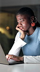 Bored, night and black woman on laptop in office for overtime with article, deadline and project. Startup, dark and person with burnout, tired and sad on computer for research, submission or report