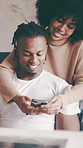 Happy couple, hug and scrolling with phone in home for social media, network or connection. Man, woman or relax with smile on mobile smartphone for online chat, texting or app together in house