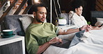 Man, relax and iv infusion with laptop for chemotherapy, minerals and browsing website. Male person, typing and pc with injection drip for cancer treatment, social media and reading news for wellness