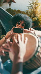 Drum, relax and woman with phone, man and music for bonding and summer vacation. Musician, friends and instrument for holiday with smile, sunglasses and hammock in backyard for creative streaming