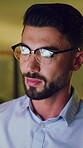 Night, reading and business man with glasses in office, market research or check investment memo. Tech reflection, overtime and banking analyst with economy trend report, financial planning or review