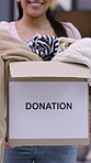 Donation, hands or box of clothes in home, sustainability practice or generosity in sharing. Eco friendly, social responsibility or woman with second hand apparel for reuse, philanthropy or charity
