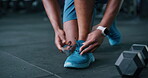 Tying, shoes and athlete in gym, hands and prepare for workout routine, feet or training for fitness. Walking, legs and person with footwear for exercise, wellness and bodybuilder with health goals