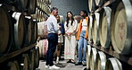 People, conversation and wine tasting in cellar with tour for winemaking process, education or info. Sommelier, friend group and talking in winery for knowledge, holiday activity or bonding together.