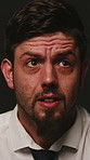 Scared, worry and businessman with interrogation for fear, nervous and confused expression. Stress, anxiety and isolated person with phobia, emotions and crisis reaction on dark studio background