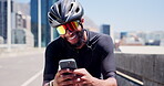 Fitness, texting or cyclist in city with mobile, message or social media scroll on cycling break. Laugh, sportswear and man on road with phone, wellness chat or internet browse in energy recovery.