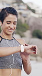 Fitness, earphones and woman with smart watch at beach for heart rate, exercise progress or results. Music, happy runner and technology for wellness stats, timer app and pace tracking for cardio