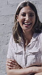 Arms crossed, laughing and face of woman in city for travel, summer vacation and funny joke. Happiness, comedy and weekend trip with portrait of person on wall background for positive attitude