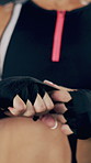 Hands, fighter and woman with training, wrap and wellness with challenge, martial arts and exercise. Closeup, person and athlete with cloth, practice and fist with mma, prepare for match and safety