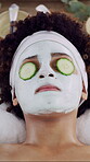 Cucumber, facial and relax with woman at spa for skincare treatment, pore detox and self care. Clay face mask, dermatology and beauty cosmetics with above of person in resort for glow and shine