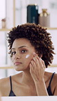 Woman, face cream and skincare in bathroom with application for collagen, retinol or anti aging benefits. Mirror, person apply moisturizer or facial treatment in home for beauty, dermatology or glow.