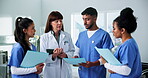 Folder, discussion or doctor with nurses in hospital, reading patient report or consulting for healthcare. Talk, nursing team or surgeon with medical history breakdown, medicine schedule or care plan
