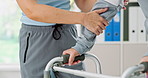 Physiotherapy, walker and hands of person and patient for help, wellness and medical service. Healthcare, clinic and physical therapist with senior patient walking for healing, mobility and recovery