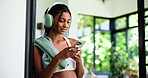 Home, headphones and woman with fitness, smartphone and listening to music, app and subscription. Audio streaming, cellphone and person with break, exercise or podcast for workout motivation or sound