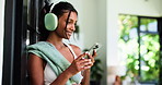 House, headphones and happy woman with fitness, cellphone and listening to music, app and sound. Audio streaming, smartphone and person with smile, exercise or dancing with song and playlist album