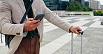 Businessman, walking and hands with phone or suitcase in city for travel, destination or commute. Man, employee or traveler with mobile smartphone for social media, texting app or chat in urban town