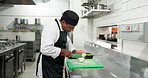 Chef, man or cut onions in restaurant for meal prep, culinary process or catering in food industry. Hospitality, cook or vegetables in kitchen for fresh ingredients, cuisine service or healthy recipe