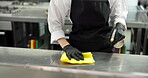 Chef, cleaning and hands with cloth, kitchen and sanitation with chemical or maintenance of surface. Wiping, workstation and person with spray for disinfection, hygiene and food safety in restaurant