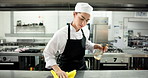 Chef, woman and spray for kitchen counter at restaurant, wipe or hygiene with sanitation process for germs. Person, cloth and bottle with chemical, liquid and cleaning product for bacteria at diner
