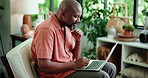 Black man, thinking or typing in home with laptop for remote work, marketing proposal or report. Mature person, planning or reading with computer in house for freelance advertising, research or idea.