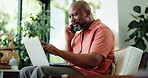 Phone call, laptop and black man in living room with freelancer, financial advice and chat in home. Remote work, account manager and mature person with tech for communication, smile and discussion