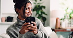 Phone, smile and thinking with woman on sofa in living room of home for social media browsing. App, scrolling and typing message with happy Indian person in apartment for ideas, planning or vision