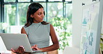 Woman, laptop or reading in office with whiteboard for data analysis, finance info or business stats. Happy female person, check graphs or typing with computer, analytics report or financial results.