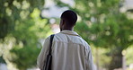 Back, student and walking with black man, outdoor and travel with urban town, scholarship and university. Explorw, commute and African person with higher education, college and pedestrian with gen z