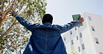 Man, student and cheering for success outdoor with good news, education and college acceptance. Back, low angle and male person with fist pump for learning achievement, scholarship winner and freedom