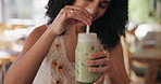 Hands, woman and stirring drink at cafe with iced matcha latte, refreshing smoothie and mix flavor. Smile, female person and green milkshake for healthy beverage, nutrition benefits and weight loss