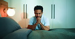 Man, praying and faith in bedroom, night and worship with routine, connection and talk with God in home. Spiritual person, religion and gratitude by bed, eyes closed and Christian belief at apartment