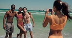 Excited, friends and picture with smartphone, beach and bonding on summer vacation, laugh and travel. Outdoor, photography and people with mobile for memory, reunion and together on holiday or sea