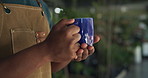 Nursery, plants and hands of man with drink for environment, greenhouse and gardening store. Relax, small business and person with coffee, beverage and calm with leaves, planting and sustainability