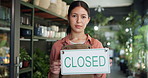 Woman, closed sign and botanist at front door, face or sustainability with board at small business. Person, florist and announcement at shop, portrait and notice at eco friendly startup in Colombia