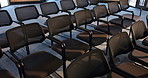 Chairs, business and empty conference room for seminar, event or expo workshop. Seats, hall and interior at convention center with rows for presentation, trade show or furniture for meeting venue
