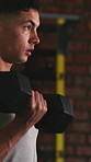 Man, serious and dumbbell in gym for weightlifting, arm muscle development and strength training. Bodybuilder, weights or hands in wellness center for fitness, bicep curl and power workout with sweat