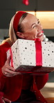 Christmas, woman and smile in home with present, gratitude and excited for festive bonding together. Family, apartment and Xmas with people, gifts and giving for holiday season and happy tradition