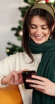 Smile, woman and phone at house on Christmas for social media, gift search and texting. Happy, female person and mobile for online shopping, reading funny meme and festive celebration with bokeh

