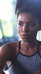 Fitness, break and black woman breathing in gym, cool down exercise and complete training for rest. Commitment, finish workout or athlete relax for wellness in sports club, peace and exhale for bokeh