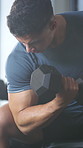 Exercise, biceps and man with weights in gym for fitness, bodybuilder training and muscle workout. Serious, athlete and person with dumbbells for strength, weightlifting and challenge for wellness