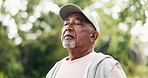 Breathe, thinking and senior man in park for fresh air, wellness and active hobby for health outdoor. and elderly person in nature for exercise, fitness and workout for wellbeing, rest and calm