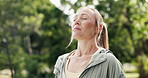 Happy, fitness and woman in park breathe for fresh air, wellness and health for active hobby. Outdoor, smile and person in nature with calm, peace and relax for exercise, workout and reflection